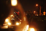 A motorist raises her fist in solidarity with a march protesting the police shooting of Jacob Blake in Kenosha, Wis., Wednesday, Aug. 26, 2020. The protests began after a white police officer shot Blake, who is Black, in the back seven times as Blake walked away from officers Aug. 23. The shooting sparked days of protests in Kenosha, a city of about 100,000 halfway between Milwaukee and Chicago. Some of the demonstrations turned violent. More than 20 businesses were set on fire and prosecutors say a 17-year-old shot and killed two men during a chaotic protest and accused him of shooting and wounding a third man in the arm.