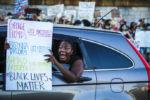 BOSTON - 6/17/2020: A Black Lives Matter protestor yells out of her car window while looping around the rotary as she joins others in participating in a counter Black Lives Matter Protest. A Law Enforcement and First Responder rally was held in West Roxbury and Black Lives Matter protestors gathered in response.