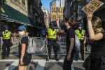 BOSTON - 6/3/2020: Protesters spill out onto Tremont Street, walking past the Boston Police, after gathering in Boston Common to honor the life of George Floyd and other Black lives taken at the hands of police. After gathering in the park, demonstrators marched through the streets.