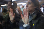 An audience member listens from behind a window as Democratic 2020 U.S. presidential candidate and U.S. Senator Elizabeth Warren (D-MA) speaks at a campaign canvass kickoff in Manchester, New Hampshire, February 8, 2020.