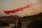 2020 was another record setting year for wildfires in Southern California. There were over 9,000 fires and over 4 million acres of forest burned.
A helicopter drops fire retardant over the Silverado Fire in Irvine, California.