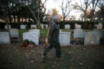 Alan Giangregorio is the foreman of the burial crew at Woodlawn Cemetery. In his half century tending to the dead, the gravedigger has seen just about everything but since COVID-19 hit last March, the funeral requests at Woodlawn havenÕt stopped coming. Each day, the departed begin a slow procession, from hospital or long-term facility, to the careful custody of the funeral home, and finally, to an 8-foot-by-3-foot resting place prepared by Giangregorio and his team, the unseen, uncelebrated back-line workers who are the last ministers to the deceased.
Everett, MA--12/10/20-- On his morning rounds Alan Giangregorio picks up a shovel that was left leaning beside a grave from a funeral held at Woodlawn Cemetery the prior evening.