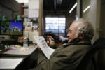 Everett, MA--12/10/20-- On his lunch break Alan Giangregorio opts for a minimal meal of a few tangerines and some fennel and sits in his friend's office inside the garage to indulge in a crossword puzzle. In his cramped cemetery office, the works of Melville and Hawthorne compete for space with time slips and grave-cleaning brushes. He is a proud member of the Greater Boston Dickens Fellowship, a group that, until recently, met monthly to toast the author over bowls of chowder at the Union Oyster House.