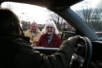 Everett, MA--12/10/20-- Diane Corkery (R) stopped Alan Giangregorio to tell him about a fallen branch and then ended up sharing a laugh with him as she and a widower chatted with him. Giangregorio's role extends far beyond gravedigger, he takes care of both the cemetery and the community at Woodlawn Cemetery always stopping to chat with regular visitors and help out with whatever they need. A deeply religious man, Alan says that when he was younger one of the nuns told him, "God put you there for a reason to help people and to strengthen their faith."