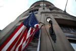 Boston, MA - 10/7/2020: Each morning at 7 a.m., Samuel Valle, a custodian atÊOne Liberty Square, raises an American flag on the flagpole outside the majestic nearly 100-year-old limestone building with a bird's eye view of Water Street. There's a plaque on its Classic Revival facade of a goddess and in Latin, the phrase, "In Omnia Paratus," or "Prepared in all things."
But who was prepared for this?