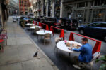 Boston, MA - 10/6/2020: Jake Horan eats his lunch outside Villa Mexico Cafe on Water Street.
Julie King and her daughter Bessie opened the Water Street eatery in 2016. This was supposed to be a milestone year for the Kings. They were set to pay off their loans and own Villa Mexico outright, and had planned a block party on Water Street to celebrate.
But 2020 didnÕt go as planned. The Kings have used savings, donations, and other aid to cover rent and payroll throughout the shutdown. Outdoor dining got them through the summer Ñ just barely Ñ with additional help from salsa sales. Bessie took a second job to bring in extra money.