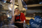 Boston, MA - 10/6/2020: Owner Julie King holds back tears at Villa Mexico Cafe on Water Street. A customer had walked out while she was on the phone with another customer who was trying to negotiate the price of an order. Having lost two customers in a matter of minutes she said, "I'm going to cry." The Kings have gone from nearly owning their business outright to being more than $30,000 in debt.