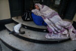 Boston, MA - 10/22/2020: Chris, who goes by the name ÒSquirrel,Ó woke up on the steps outside Max's Deli Cafe, now closed due to the pandemic. Chris has been homeless off and on since 2000 and struggles with addiction. He said panhandling has become more difficult since the pandemic began. "It's hard, people don't want to talk you, they don't want to help you. People used to ask, 'how you doing?' Now they walk around you," he said.