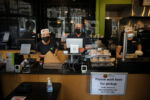 Boston, MA - 10/7/2020: Owner Elias Khoury, center, works the register during the lunch hour at Pita Thyme on Water Street.
Prior to the pandemic Pita Thyme was a favorite for many, with lines out the door. There was even a must-have dish: the chicken shawarma plate with a choice of sides but always the crispy spicy potatoes, which some declare the best menu item on Water Street. Now a customer is often outnumbered by employees six to one.
Khoury and his wife Louma received a federal Paycheck Protection Program loan early in the pandemic, but burned through it paying workers while they were still closed. They convinced their landlord to let them defer some of their rent payments, but they havenÕt taken a paycheck in months and are drawing down on their savings.
