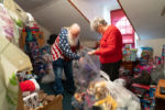 Sheila and Dennis start bagging the toys that they have collected throughout the year as they are preparing to donate them to various Rhode Island charities.