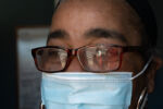 ocially distant while wearing PPE, Dennis is reflected through a pair of glasses as he donates the more food to a local Rhode Island family shelter.