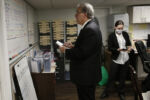 East Boston, MA - 4/28/20 - Funeral director Joe Ruggiero Jr., founder of his familyÕs business, Ruggiero Family Memorial Home in East Boston, looked up at the white board full of funerals for the week as he tried to figure out the next dayÕs staffing beside his daughter, Catie.