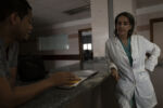 From 2015-2016 alone Venezuela saw a 65% increase in maternal mortality according to Amnesty International. Then again in 2018 Venezuela saw another 65% increase in maternal mortality over the previous year according to a report from the University of Miami. The main causes, a lack of medicine and a lack of doctors. Dr. Luisangela Correa is an Emergency General Surgeon that supports Ob/Gyn in the Concepción Palacios Maternity Hospital in Caracas, Venezuela. For 19 years she has been working in the ob/gyn public hospital sector of Caracas. The public hospital sector of Caracas used to be reliable and dependable, a high quality system. Dr. Correa spends her days fighting for woman to have a place to give birth and receive gynecological care. In the last year alone Dr. Correa has seen her number of colleagues drop to less than half. Many have left the country due to the ongoing political crisis. What was once 6 surgeons is now 2. She is currently working without pay. She tells me, “If I don’t do this job, no one will. Here, there is no one left.”
Dr. Correa talks with her Resident Ronald about a case. Dr. Correa has been training Ronald hoping he will stay on at the hospital after his residency. Although she knows it is unlikely, as most leave the country after school for more opportunities.