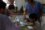 From 2015-2016 alone Venezuela saw a 65% increase in maternal mortality according to Amnesty International. Then again in 2018 Venezuela saw another 65% increase in maternal mortality over the previous year according to a report from the University of Miami. The main causes, a lack of medicine and a lack of doctors. Dr. Luisangela Correa is an Emergency General Surgeon that supports Ob/Gyn in the Concepción Palacios Maternity Hospital in Caracas, Venezuela. For 19 years she has been working in the ob/gyn public hospital sector of Caracas. The public hospital sector of Caracas used to be reliable and dependable, a high quality system. Dr. Correa spends her days fighting for woman to have a place to give birth and receive gynecological care. In the last year alone Dr. Correa has seen her number of colleagues drop to less than half. Many have left the country due to the ongoing political crisis. What was once 6 surgeons is now 2. She is currently working without pay. She tells me, “If I don’t do this job, no one will. Here, there is no one left.”
Dr. Correa having dinner with her family. Fighting for the care of women at the hospital takes so much of her time and energy that most days she comes home and only sees her family for dinner.