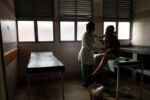 From 2015-2016 alone Venezuela saw a 65% increase in maternal mortality according to Amnesty International. Then again in 2018 Venezuela saw another 65% increase in maternal mortality over the previous year according to a report from the University of Miami. The main causes, a lack of medicine and a lack of doctors. Dr. Luisangela Correa is an Emergency General Surgeon that supports Ob/Gyn in the Concepción Palacios Maternity Hospital in Caracas, Venezuela. For 19 years she has been working in the ob/gyn public hospital sector of Caracas. The public hospital sector of Caracas used to be reliable and dependable, a high quality system. Dr. Correa spends her days fighting for woman to have a place to give birth and receive gynecological care. In the last year alone Dr. Correa has seen her number of colleagues drop to less than half. Many have left the country due to the ongoing political crisis. What was once 6 surgeons is now 2. She is currently working without pay. She tells me, “If I don’t do this job, no one will. Here, there is no one left.”
Dr. Correa changes the catheter of a patient who needs surgery to remove a tumor. She cannot operate due to no anesthesiologist, and no sterile supplies.