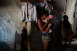 From 2015-2016 alone Venezuela saw a 65% increase in maternal mortality according to Amnesty International. Then again in 2018 Venezuela saw another 65% increase in maternal mortality over the previous year according to a report from the University of Miami. The main causes, a lack of medicine and a lack of doctors. Dr. Luisangela Correa is an Emergency General Surgeon that supports Ob/Gyn in the Concepción Palacios Maternity Hospital in Caracas, Venezuela. For 19 years she has been working in the ob/gyn public hospital sector of Caracas. The public hospital sector of Caracas used to be reliable and dependable, a high quality system. Dr. Correa spends her days fighting for woman to have a place to give birth and receive gynecological care. In the last year alone Dr. Correa has seen her number of colleagues drop to less than half. Many have left the country due to the ongoing political crisis. What was once 6 surgeons is now 2. She is currently working without pay. She tells me, “If I don’t do this job, no one will. Here, there is no one left.”
Nicole, 14 yrs. old, and her 2 week old baby girl at their home in Petare. The poor barrio of Petare is the epicenter of this crisis.