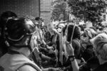 Black Lives Matter protesters chant “I can’t breathe” and “Who do you protect?” to police officers in front of the Boston Police District 4 station in Roxbury on May 29, 2020.