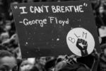 A protester holds a sign that says "I Can't Breathe" at a protest in Franklin Park on June 2, 2020.