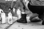A street medic mixes milk and baking soda at a makeshift care site to aid individuals who were pepper-sprayed by the police at a May 29, 2020 protest.