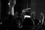 Protesters raise their hands and say "Hands up. Don't shoot" as police officers watch at a Sept. 25, 2020 protest in downtown Boston.