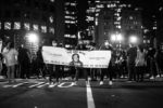 Protesters hold a sign in solidarity with Breonna Taylor at a Black Lives Matter protest outside of Boston City Hall on Sept. 25, 2020.