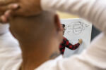 Renaldo puts his hands behind his head during a class taught by Shayne Priddy. Priddy has a master’s in psychology and teaches residents coping techniques, emotional intelligence, and the thinking behind dependency.