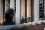 A police officer watches demonstrators from the balcony of the Massachusetts Statehouse at a Black Lives Matter protest on May 31, 2020.