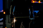 A police officer grips a baton outside the Boston Police District 4 Neighborhood Station on May 29, 2020.