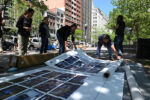 Preparing to hang banners on the photo cubes. Photo by Meredith Nierman. Preparing to hang banners on the photo cubes. Photo by Meredith Nierman.